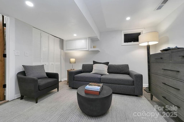 living room featuring recessed lighting, visible vents, baseboards, and light colored carpet