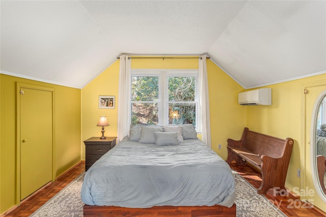 bedroom with lofted ceiling, an AC wall unit, and a textured ceiling