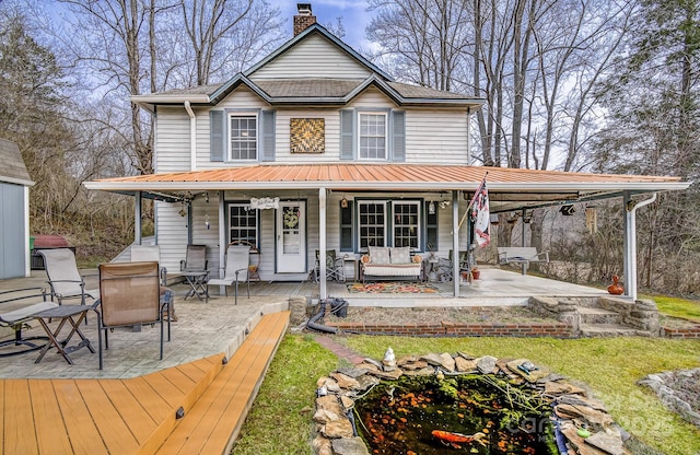 view of front of house featuring a porch and a chimney