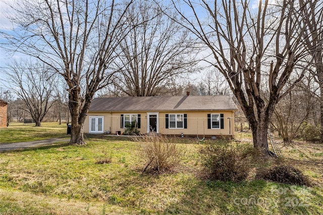 ranch-style home with a front lawn, crawl space, and a chimney