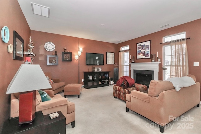 living room with carpet, a fireplace, and visible vents