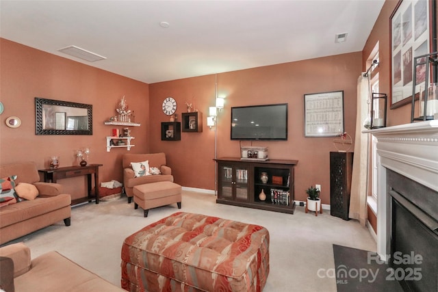 living area featuring carpet floors, visible vents, a fireplace, and baseboards