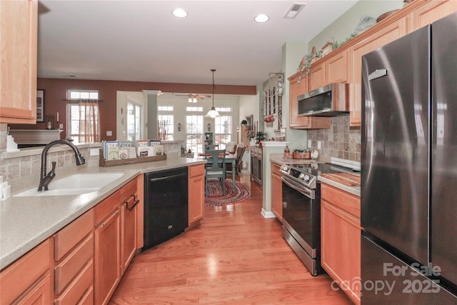 kitchen featuring a wealth of natural light, visible vents, appliances with stainless steel finishes, and a sink