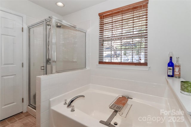 bathroom featuring a stall shower, a garden tub, and recessed lighting