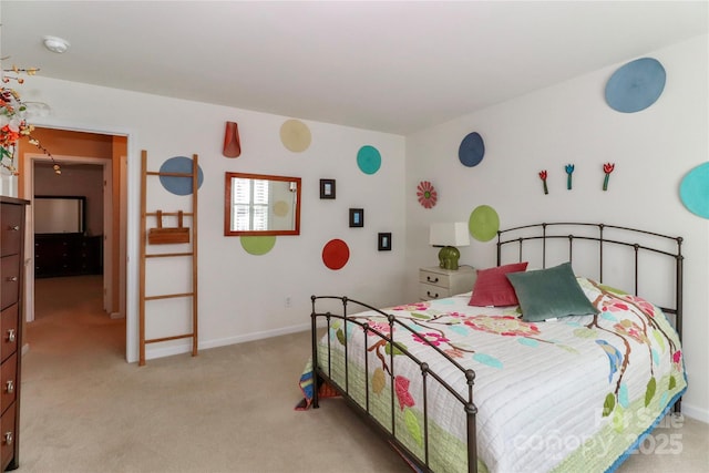 bedroom with light colored carpet and baseboards