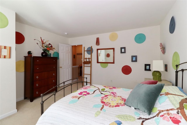 bedroom featuring light colored carpet and baseboards