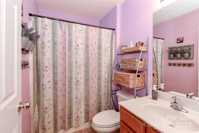 bathroom featuring toilet and vanity