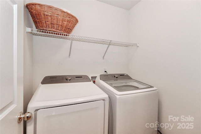 clothes washing area with laundry area and washer and clothes dryer