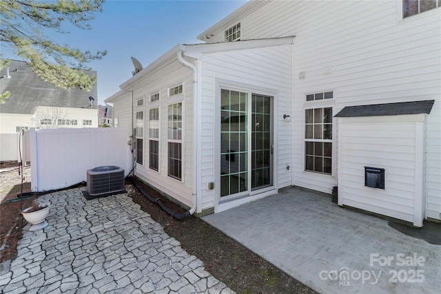 view of patio / terrace with central AC and fence