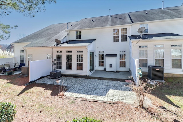 rear view of house with central AC unit and a patio area