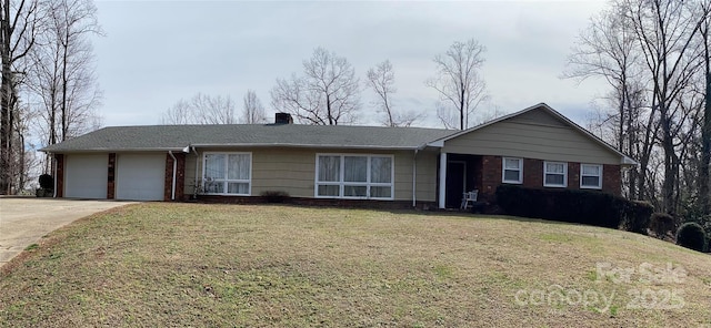 ranch-style home with an attached garage, brick siding, driveway, a front lawn, and a chimney