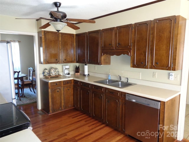 kitchen with appliances with stainless steel finishes, light countertops, and a sink