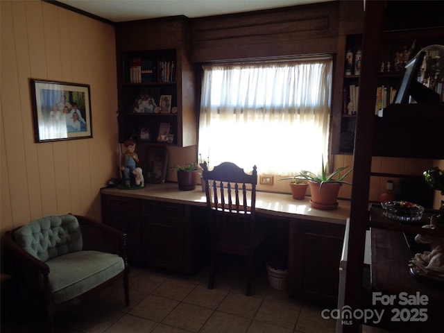 office with light tile patterned floors and wooden walls