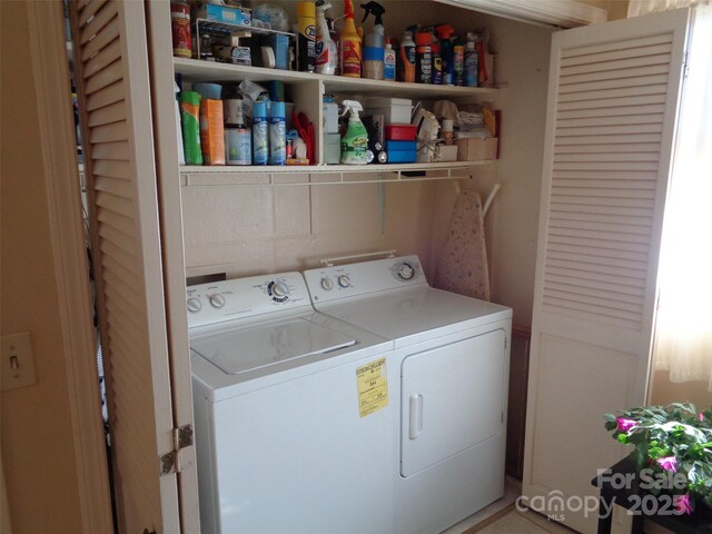 clothes washing area featuring laundry area and washing machine and dryer