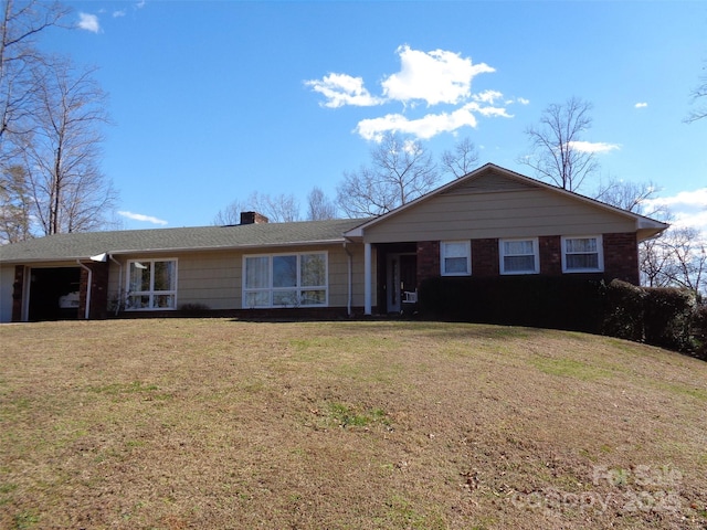 single story home featuring a front yard, brick siding, and a chimney