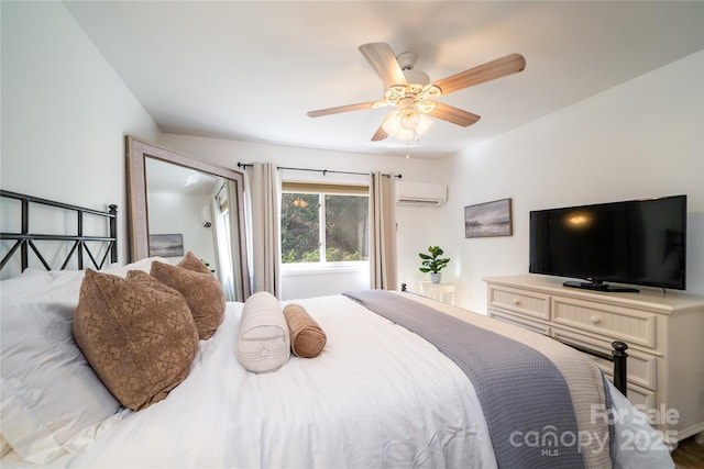 bedroom featuring a ceiling fan and an AC wall unit