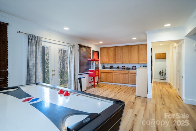 kitchen with brown cabinets, crown molding, light wood finished floors, recessed lighting, and light countertops