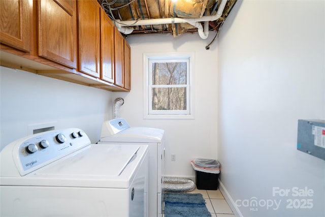 washroom with cabinet space, light tile patterned floors, baseboards, and independent washer and dryer