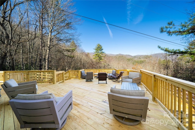 deck featuring a mountain view and outdoor lounge area