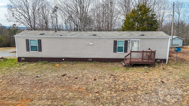 rear view of property with crawl space and a lawn