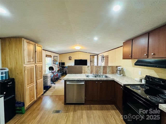 kitchen with under cabinet range hood, electric range, a sink, light countertops, and stainless steel dishwasher