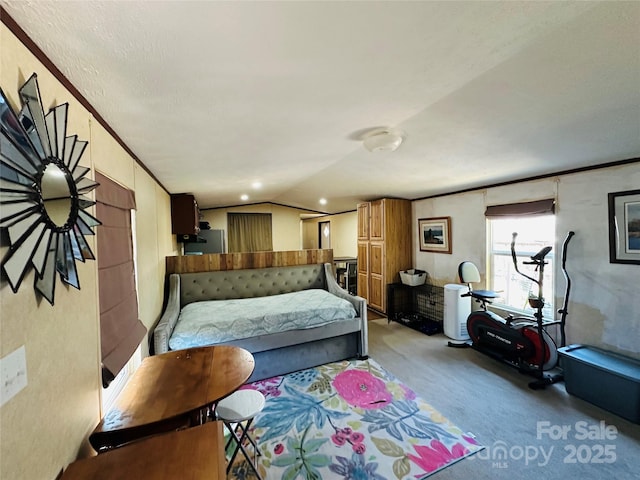 bedroom featuring ornamental molding, lofted ceiling, light colored carpet, and refrigerator