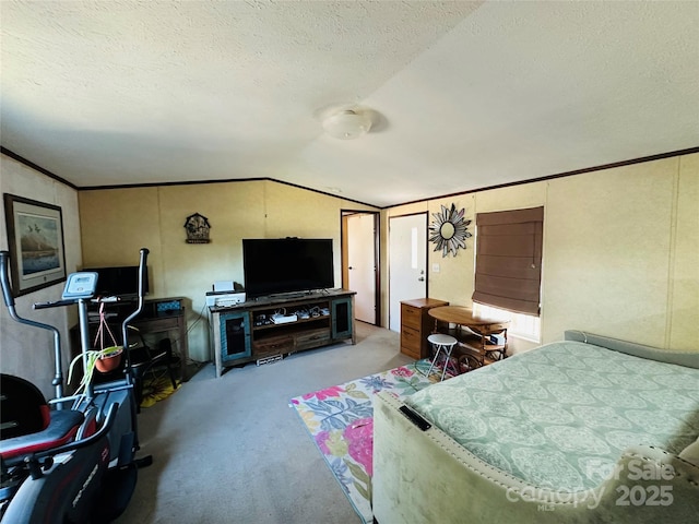 bedroom with vaulted ceiling, carpet floors, ornamental molding, and a textured ceiling