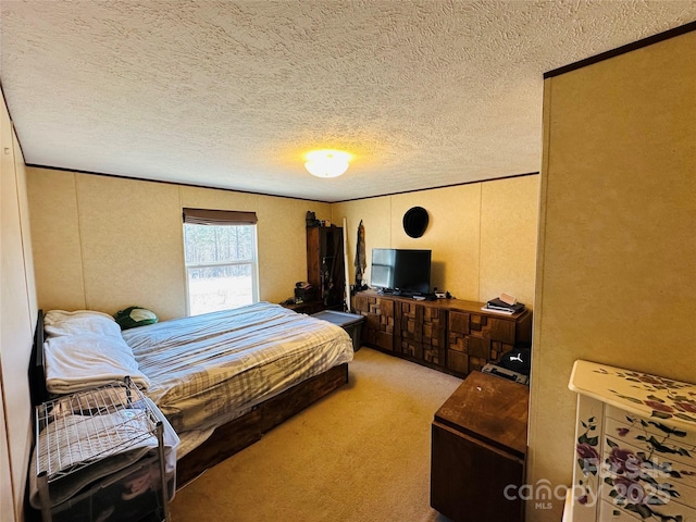 bedroom with light carpet and a textured ceiling