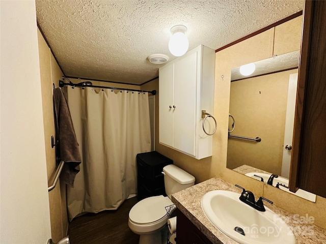 full bathroom featuring visible vents, toilet, wood finished floors, a textured ceiling, and vanity