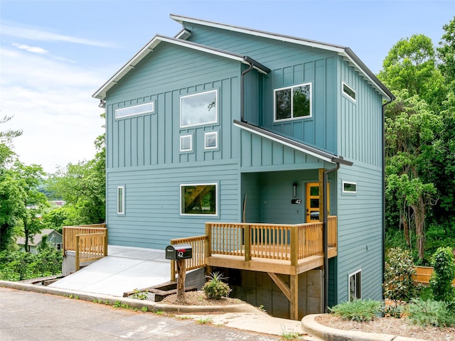 view of front of house with a deck and board and batten siding