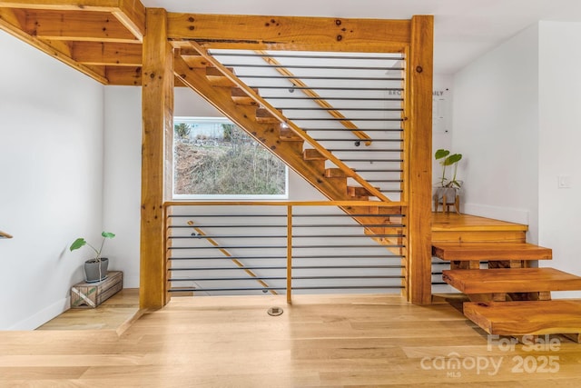 stairs with baseboards and wood finished floors