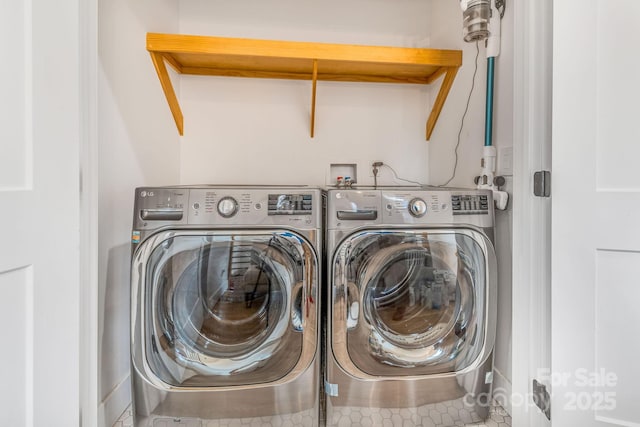 clothes washing area featuring laundry area and washing machine and dryer