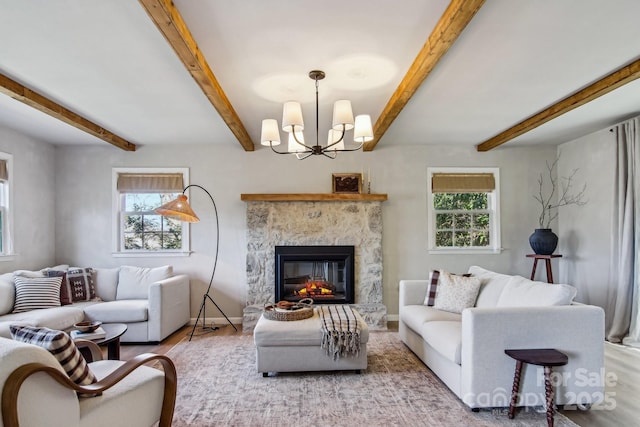 living area featuring plenty of natural light, a premium fireplace, wood finished floors, and beamed ceiling