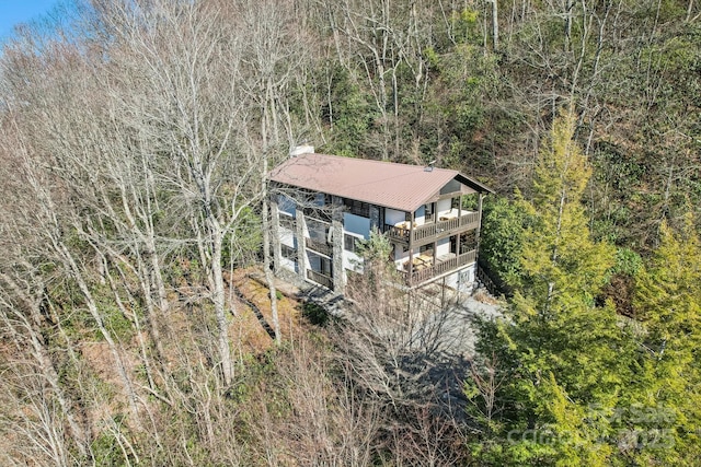 aerial view featuring a wooded view