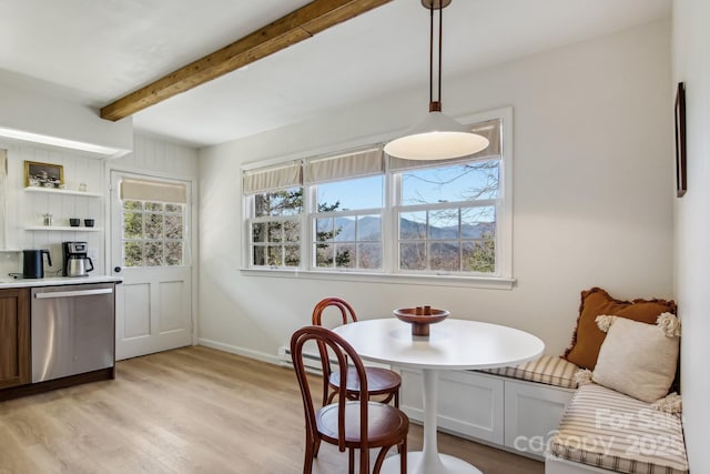 dining space with beam ceiling, breakfast area, baseboard heating, light wood-style floors, and baseboards