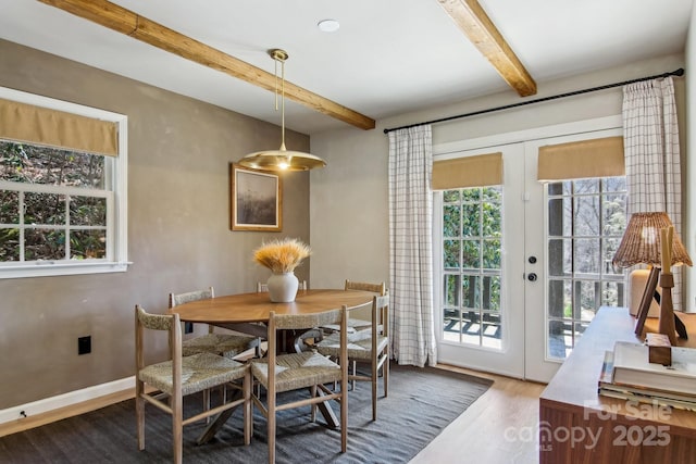 dining room featuring french doors, wood finished floors, beam ceiling, and baseboards