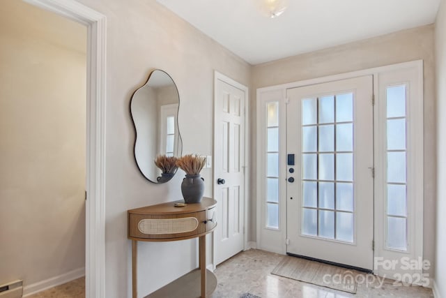 doorway with visible vents and baseboards