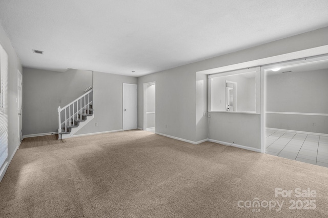 5948 Deveron Dr, Charlotte, NC 28211 - unfurnished living room featuring carpet floors, baseboards, and stairway