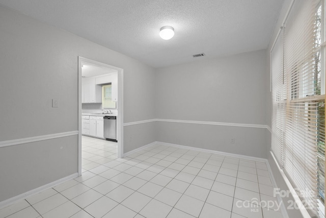 5948 Deveron Dr, Charlotte, NC 28211 - spare room featuring baseboards, a textured ceiling, visible vents, and light tile patterned floors