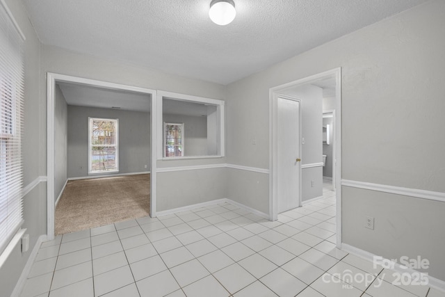 5948 Deveron Dr, Charlotte, NC 28211 - spare room featuring light tile patterned floors, baseboards, and a textured ceiling