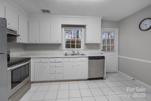 5948 Deveron Dr, Charlotte, NC 28211 - kitchen with light countertops, under cabinet range hood, a sink, visible vents, and appliances with stainless steel finishes