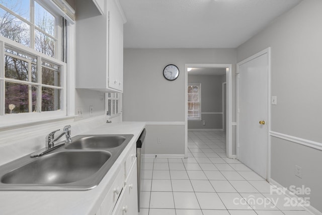 5948 Deveron Dr, Charlotte, NC 28211 - kitchen with white cabinets, light countertops, a sink, and light tile patterned floors