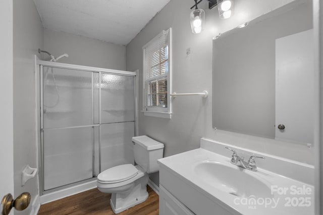 5948 Deveron Dr, Charlotte, NC 28211 - full bathroom with toilet, vanity, wood finished floors, and a shower stall