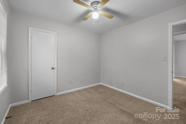 5948 Deveron Dr, Charlotte, NC 28211 - unfurnished bedroom featuring baseboards, carpet flooring, a textured ceiling, and a ceiling fan