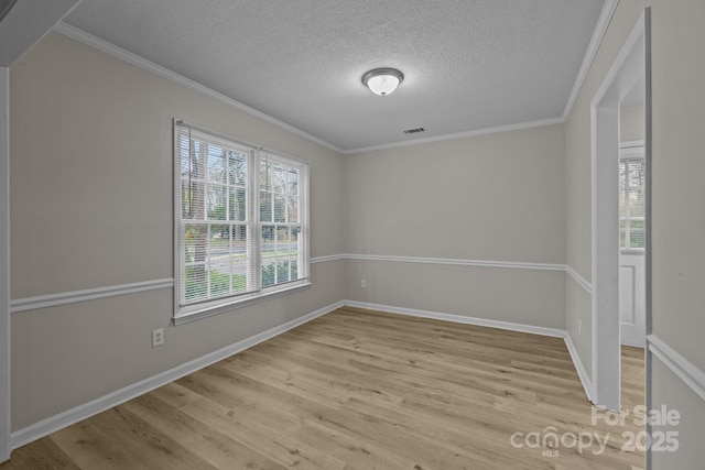 5948 Deveron Dr, Charlotte, NC 28211 - empty room featuring baseboards, light wood-style flooring, visible vents, and ornamental molding