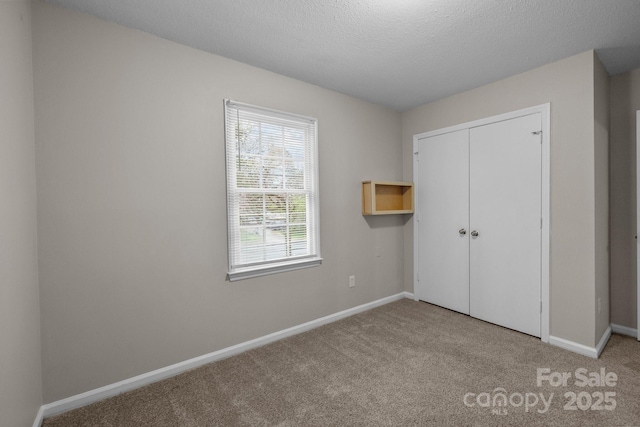 5948 Deveron Dr, Charlotte, NC 28211 - unfurnished bedroom with carpet, a closet, a textured ceiling, and baseboards