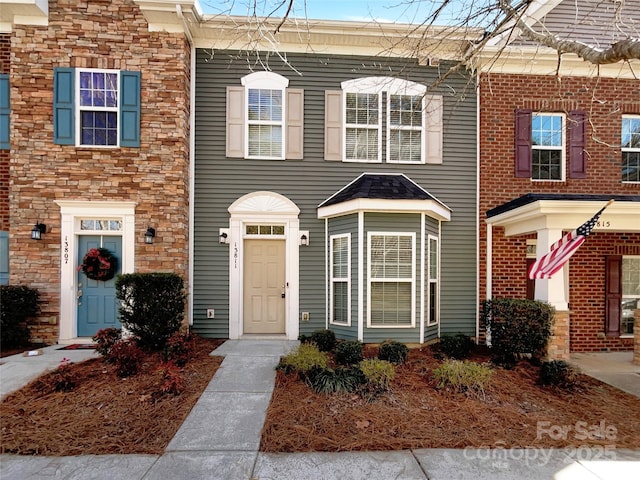 townhome / multi-family property with stone siding