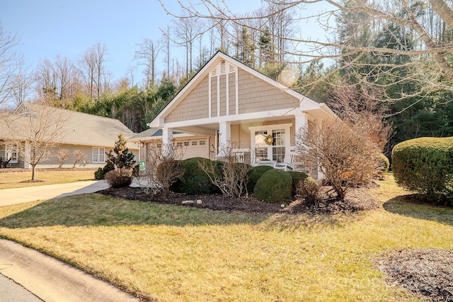 view of front of property featuring an attached garage and a front yard