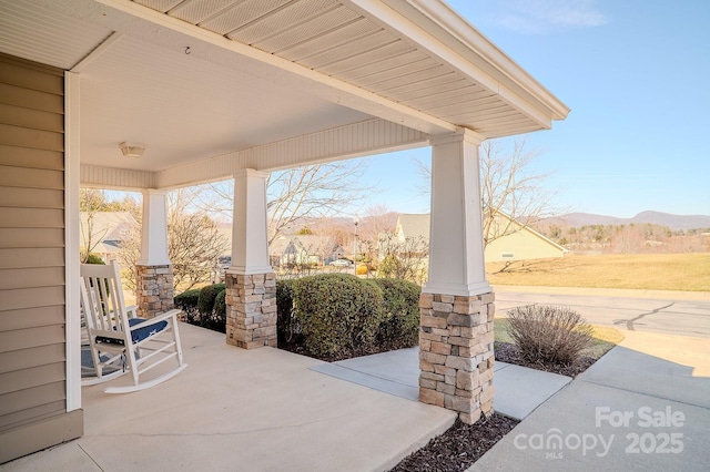 view of patio / terrace with covered porch and a mountain view