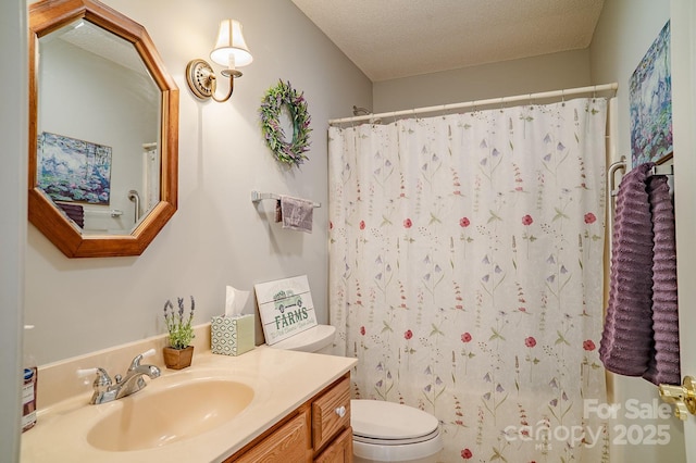 bathroom with a textured ceiling, a shower with shower curtain, vanity, and toilet